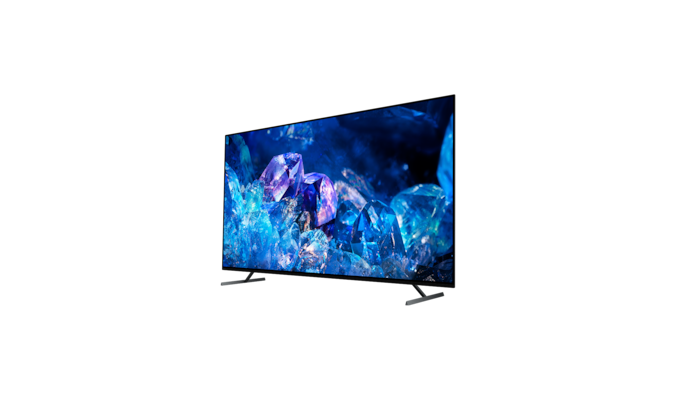 Телевизор BRAVIA A80K с подставкой и изображением синих и фиолетовых кристаллов на экране, вид с угла сзади