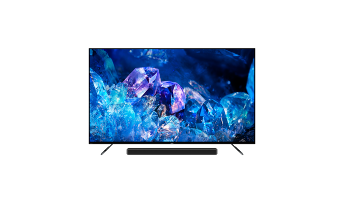 Телевизор BRAVIA A80K на подставке с саундбаром и изображением голубых и фиолетовых кристаллов на экране, вид спереди