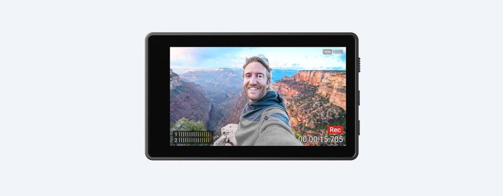 Дисплей Vlog Monitor, на котором показан мужчина, снимающий себя в живописном месте