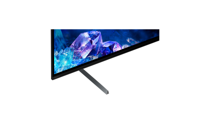 Телевизор BRAVIA A80K с подставкой и изображением синих и фиолетовых кристаллов на экране, крупный план