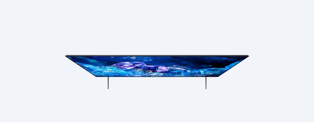 Телевизор BRAVIA A80K с подставкой и изображением синих и фиолетовых кристаллов на экране, вид сверху