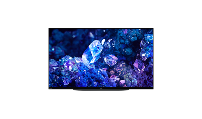Телевизор BRAVIA A90K с изображением синих и фиолетовых кристаллов на экране, вид спереди