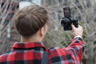 Изображение человека, снимающего видео на камеру в вертикальном положении