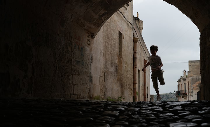 Пример изображения, на котором показан ребенок, бегущий в затененном туннеле